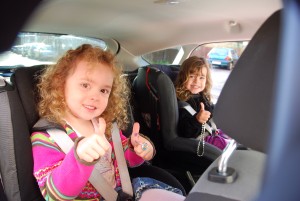 Kids thumbs up in back of focus